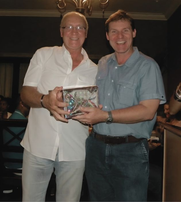 Bradley handing over a gift to a valued employee.
